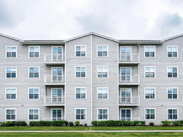 Multifamily housing exterior with windows and siding